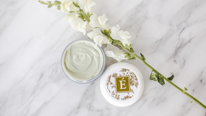 Eminence Organics moisturizer on marble background with lid off