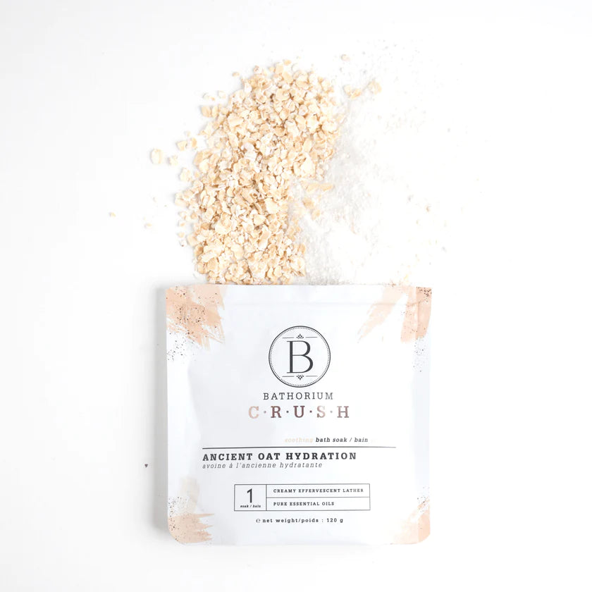 Bathorium crush bath soak ancient oat hydration open package with oatmeal spilling out, on white background