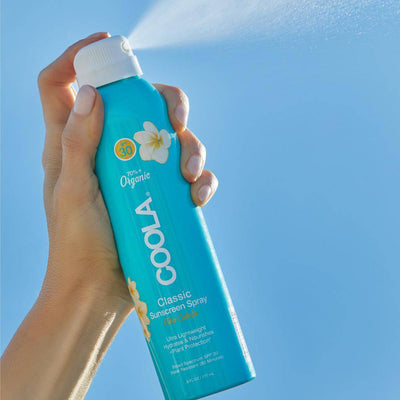 Coola Body SPF 30 Pina Colada Organic Sunscreen Spray  spraying in the air - Radiance Clean Beauty